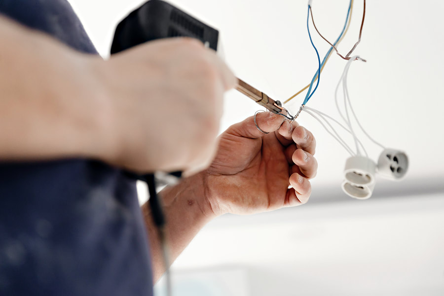 man soldering electric wires