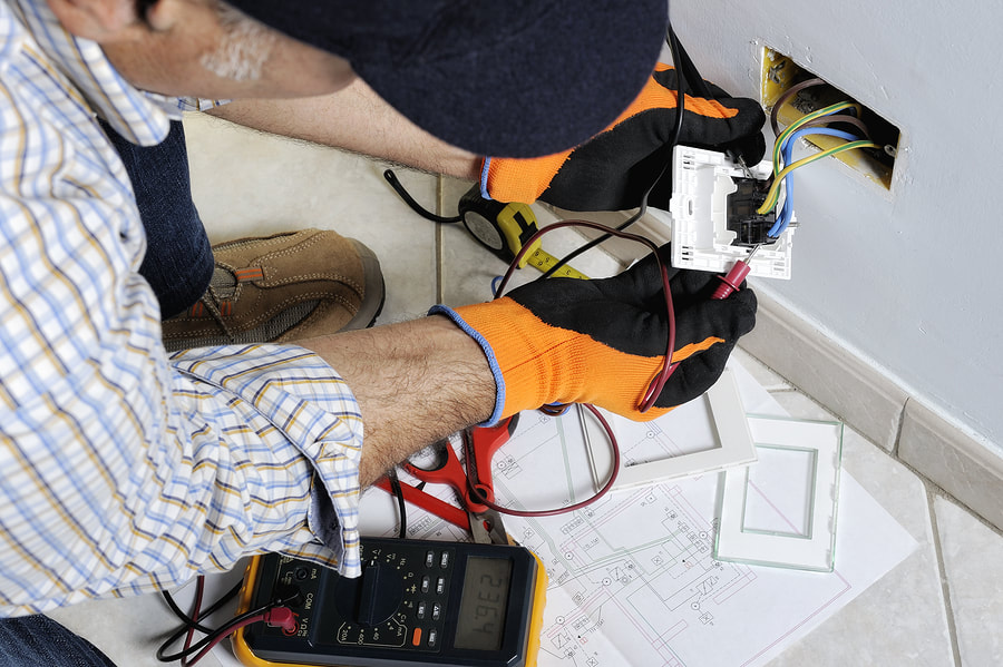 man installing electric socket